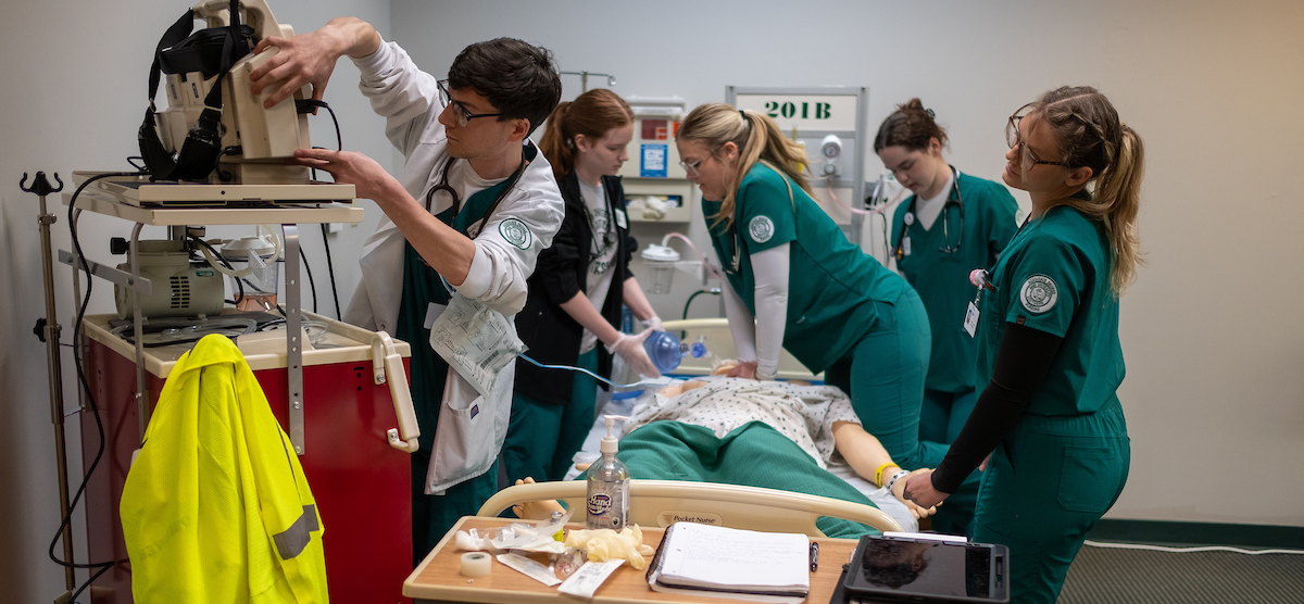 Group of students working in nursing lab