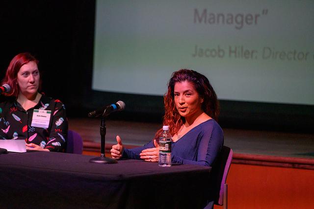 Kate Raney and Susan Cenci speaking into a microphone at the Business of Games Summit