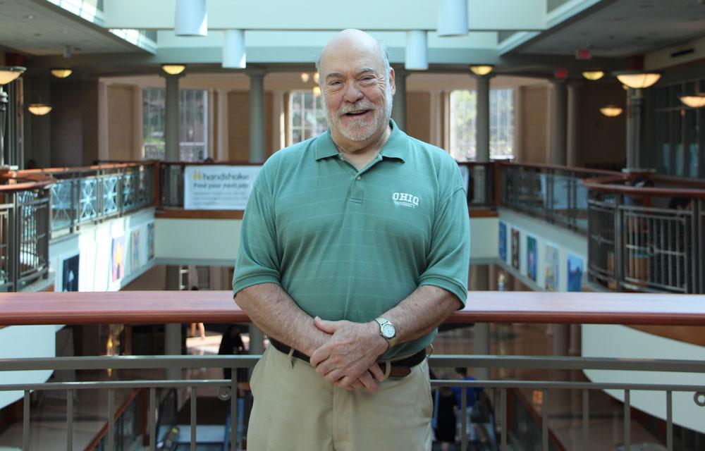 Rod Sauer standing in Baker Center