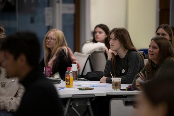 Student listening at table