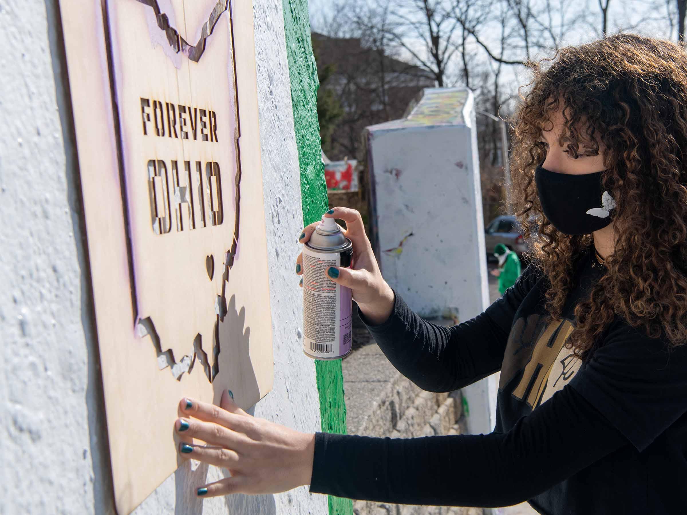 Stencil painting on graffiti wall