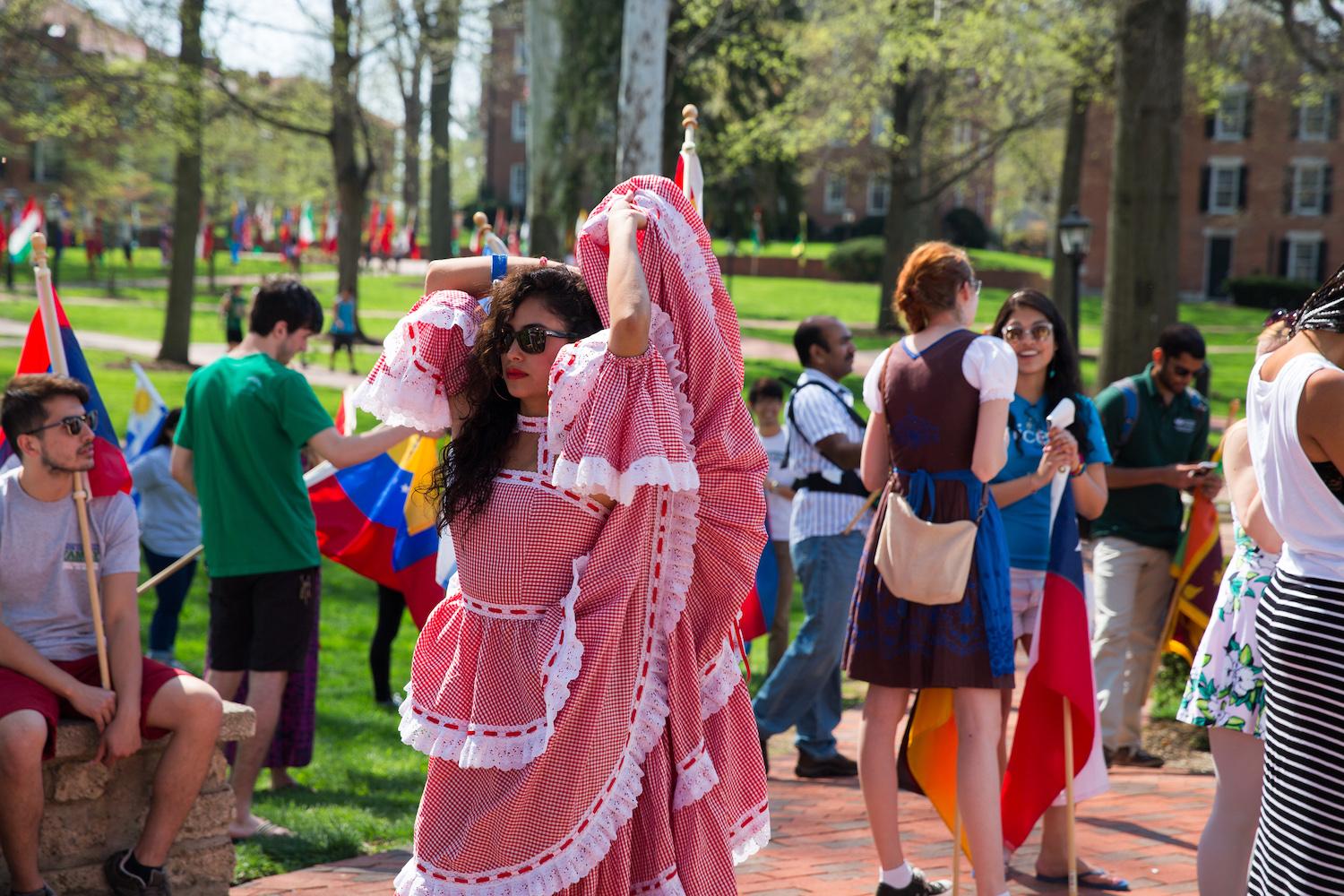 Jessica Gonzalea, dances around college green in her Spanish flamenco dress before the start of the 2015 International Street Fair Parade.