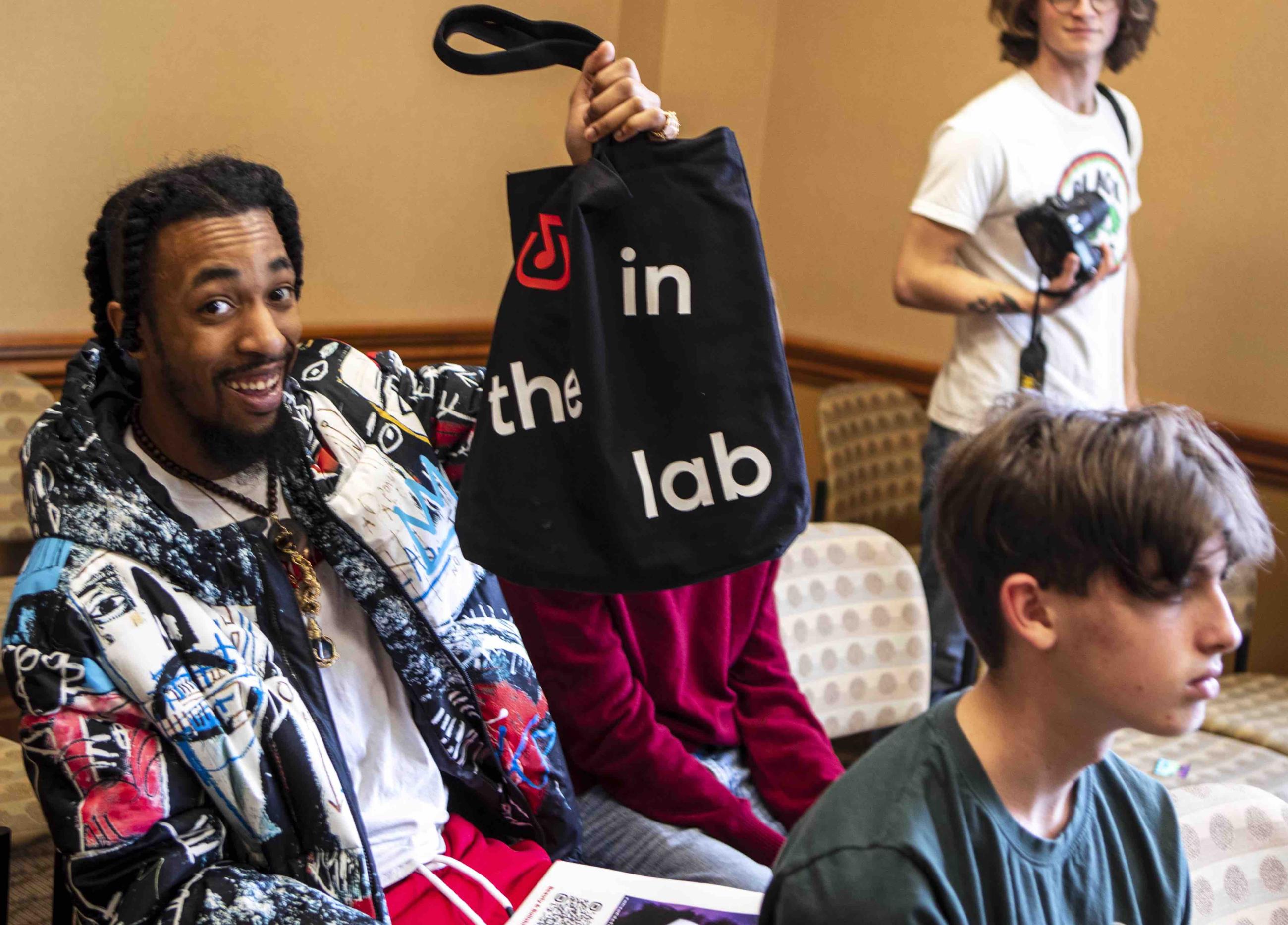 Student holding up goody bag won in a giveaway