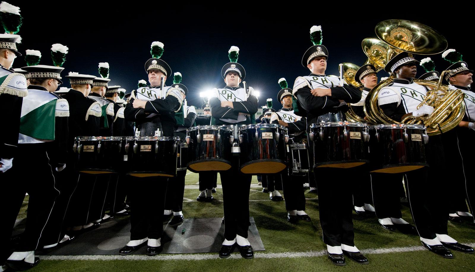 Members of The Marching 110 percussion stand ready to perform