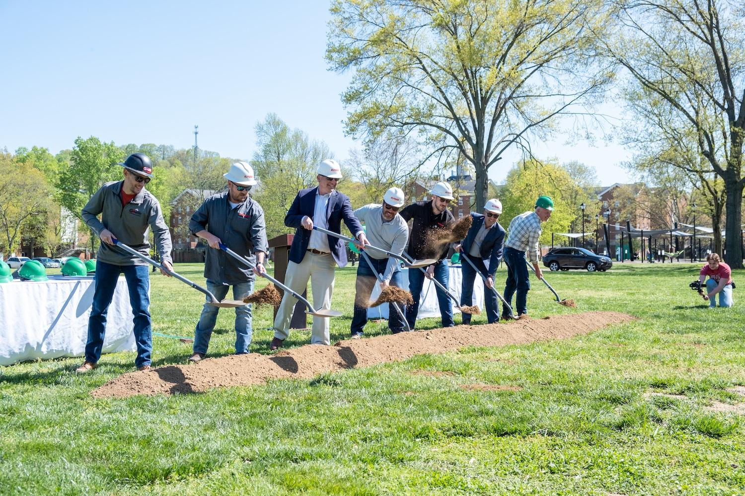 design team shoveling ceremonial dirt