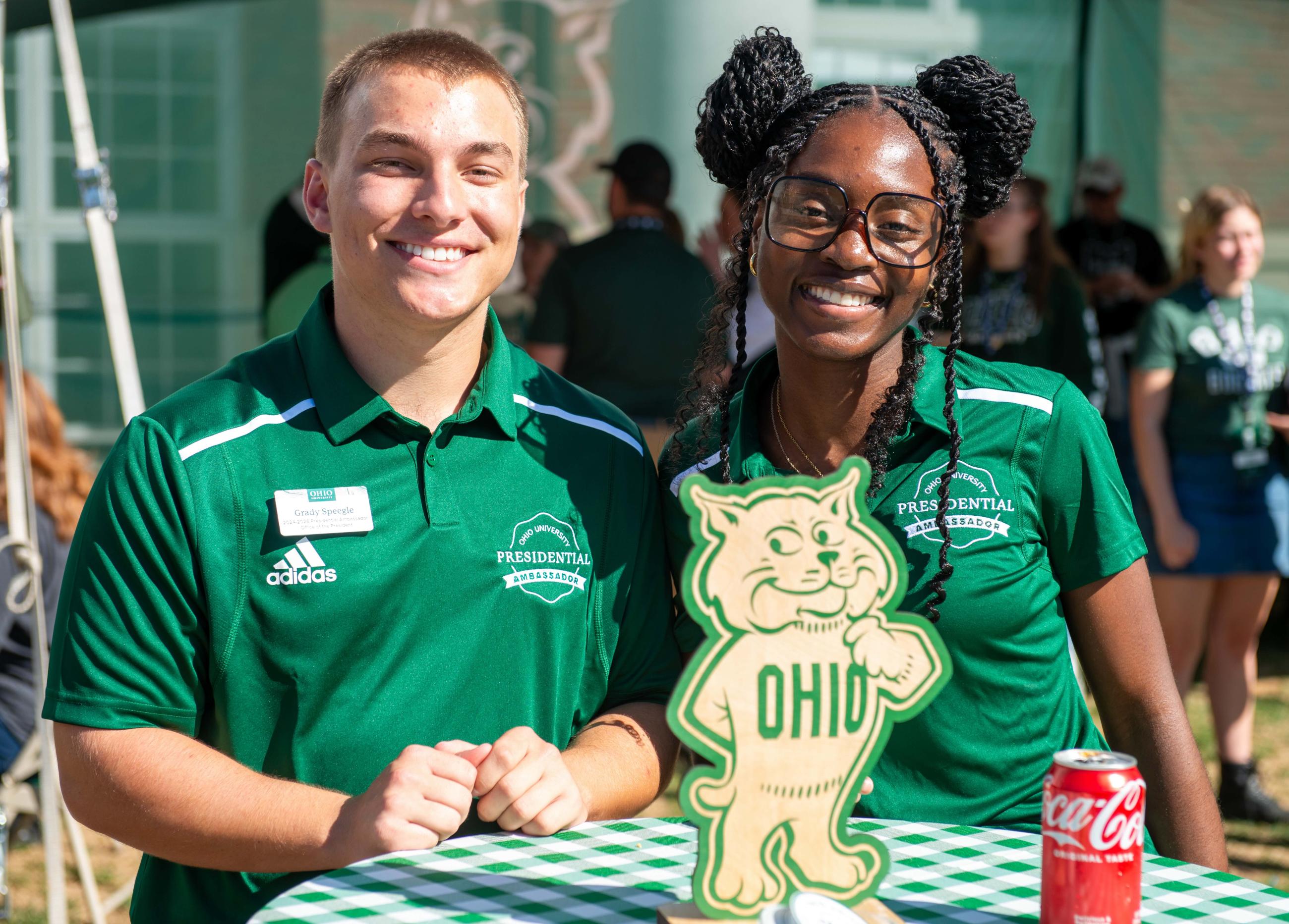 Two Presidential Ambassadors smile for a photo at the President's Tailgate, which takes place before every home football game.