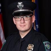 Headshot of McCollister in OUPD uniform