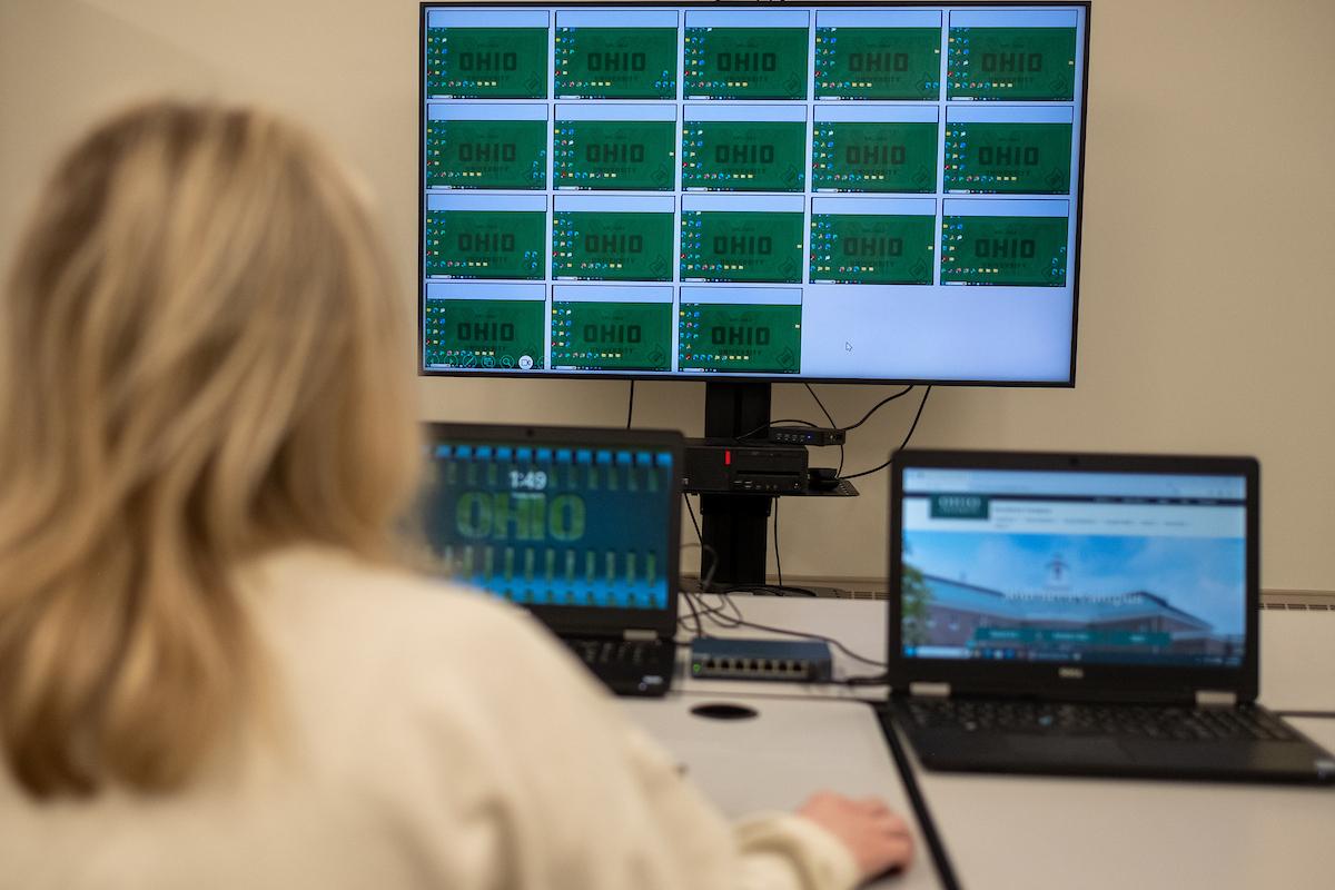 Young woman in front of two laptops