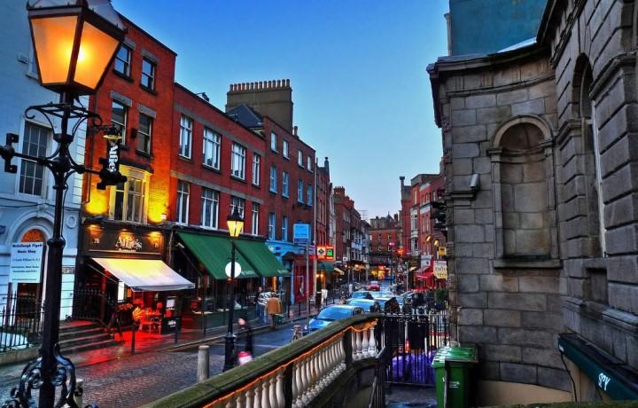 City street in Ireland at dusk and lit up with street lights.
