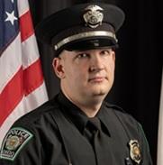 Headshot of McCollister in OUPD uniform