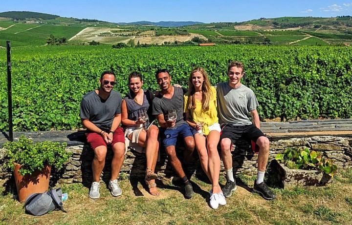 Group photo in front of beautiful green field in Portugal.