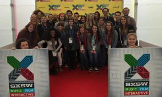 Students posing with SXSW signs