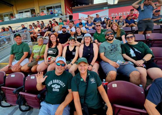 Group of alumni in stadium seating.