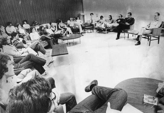 Black and white photo of a classroom of students seated in a circular pattern facing instructors at Ohio Univeristy Eastern in the 1960's 