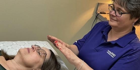 Practitioner performing Reiki on a client