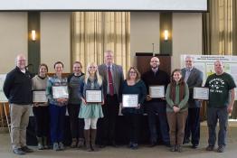 people holding plaques 