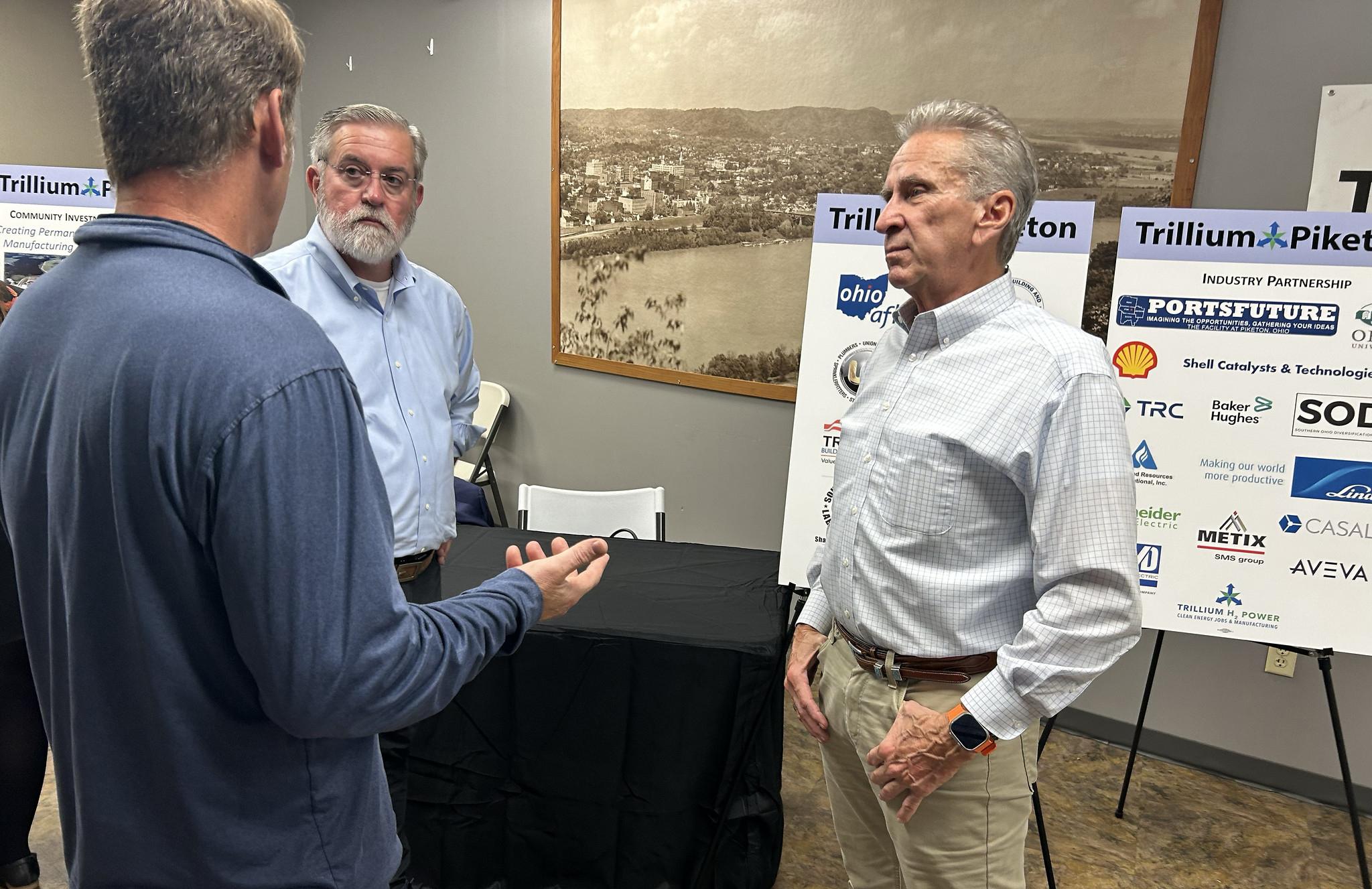 Three people in discussion at an PORTS site open house.
