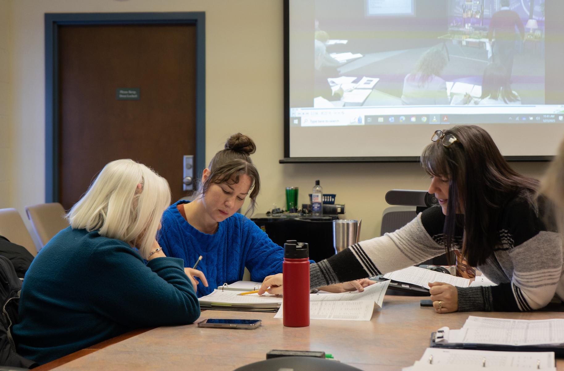 Small Business Development Center Staff aids client during a class activity.