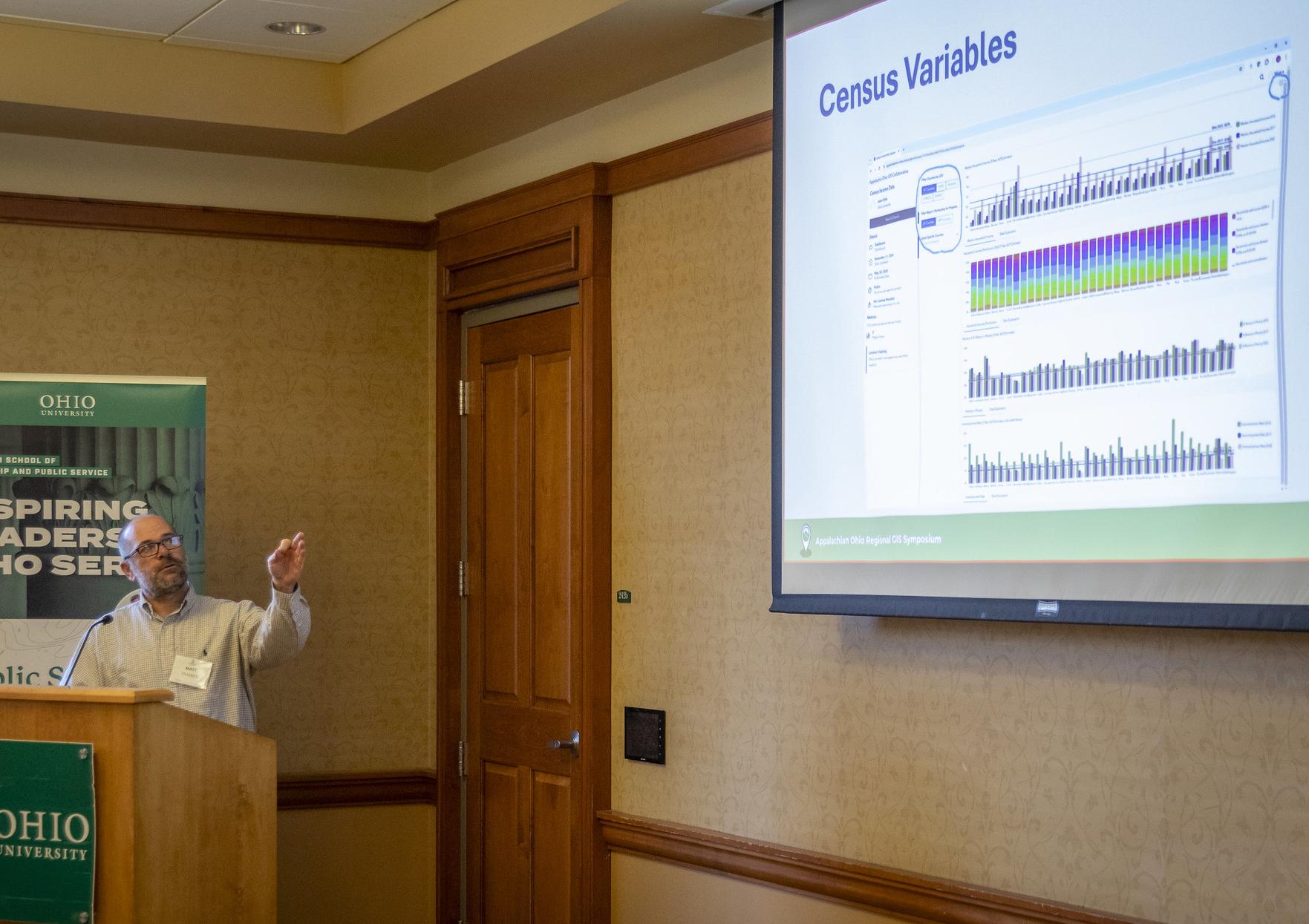 presenter points to data on screen