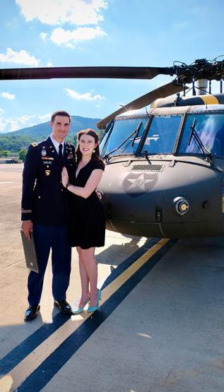 Shannon Hamelund standing in front of military helicopter 
